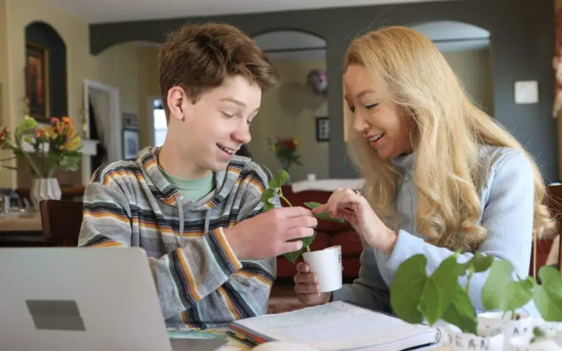 Mother and son working with a plant together at home